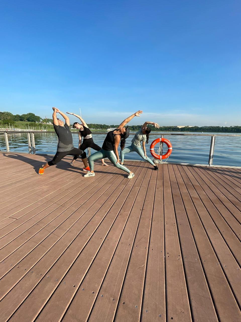 An expressive pose on a pier under a dramatic sky